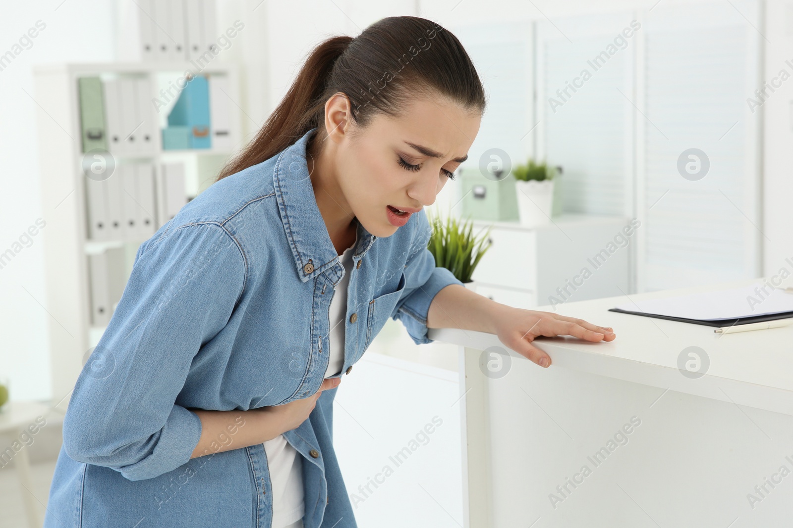 Photo of Young woman having heart attack in clinic