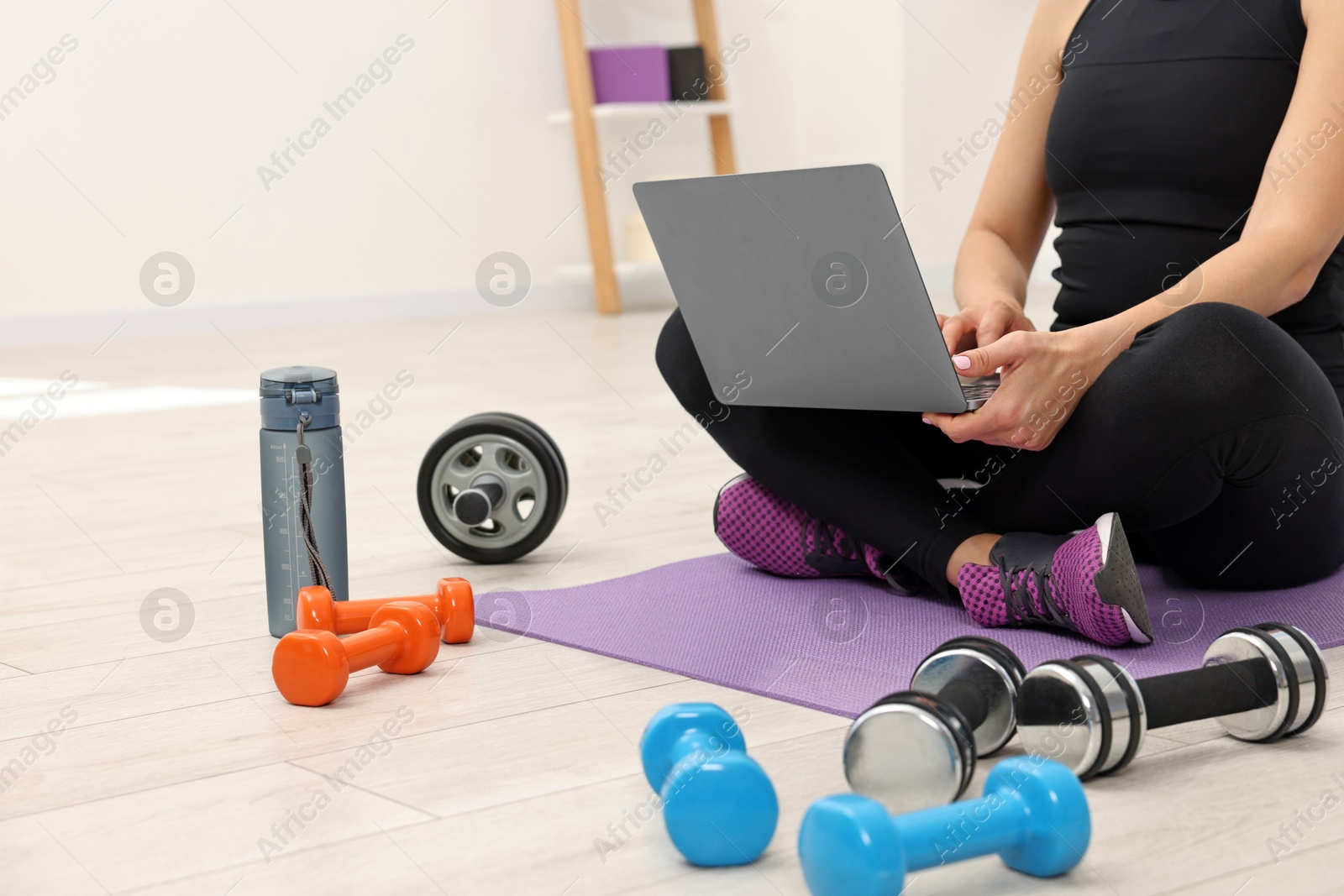 Photo of Online fitness trainer. Woman watching tutorial on laptop indoors, closeup