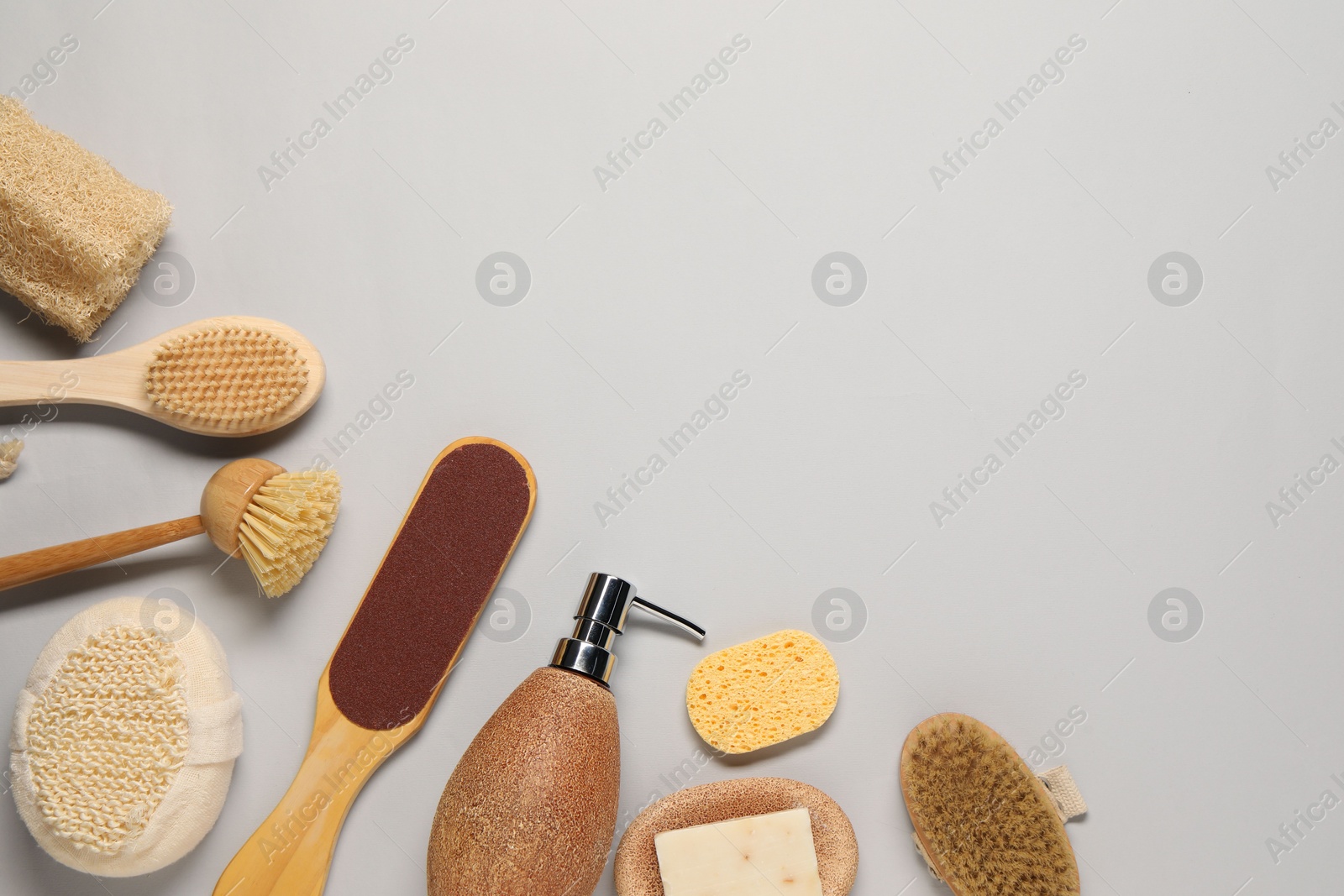 Photo of Bath accessories. Flat lay composition with personal care tools on light grey background, space for text