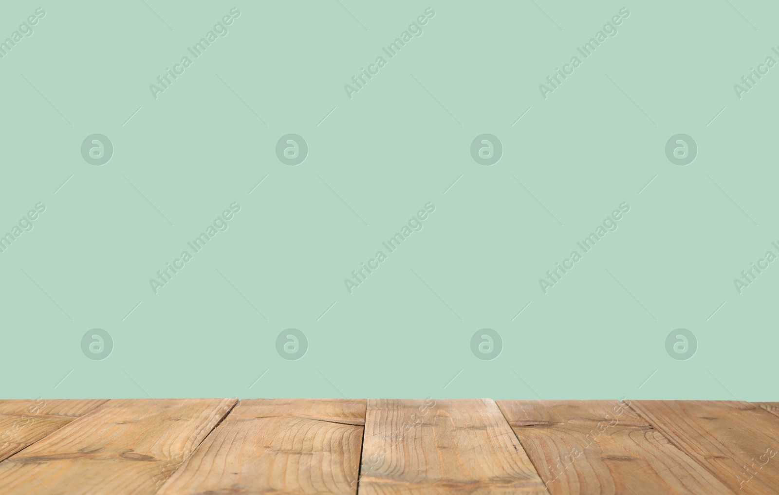 Image of Empty wooden surface on mint background. Mockup for design