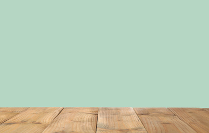 Empty wooden surface on mint background. Mockup for design