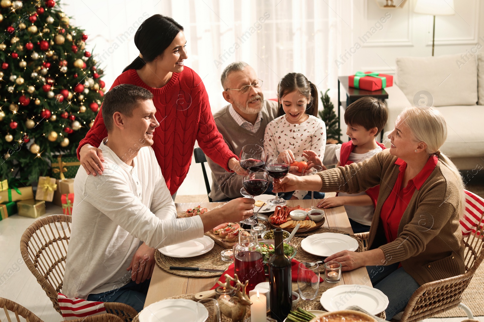 Photo of Happy family enjoying festive dinner at home. Christmas celebration