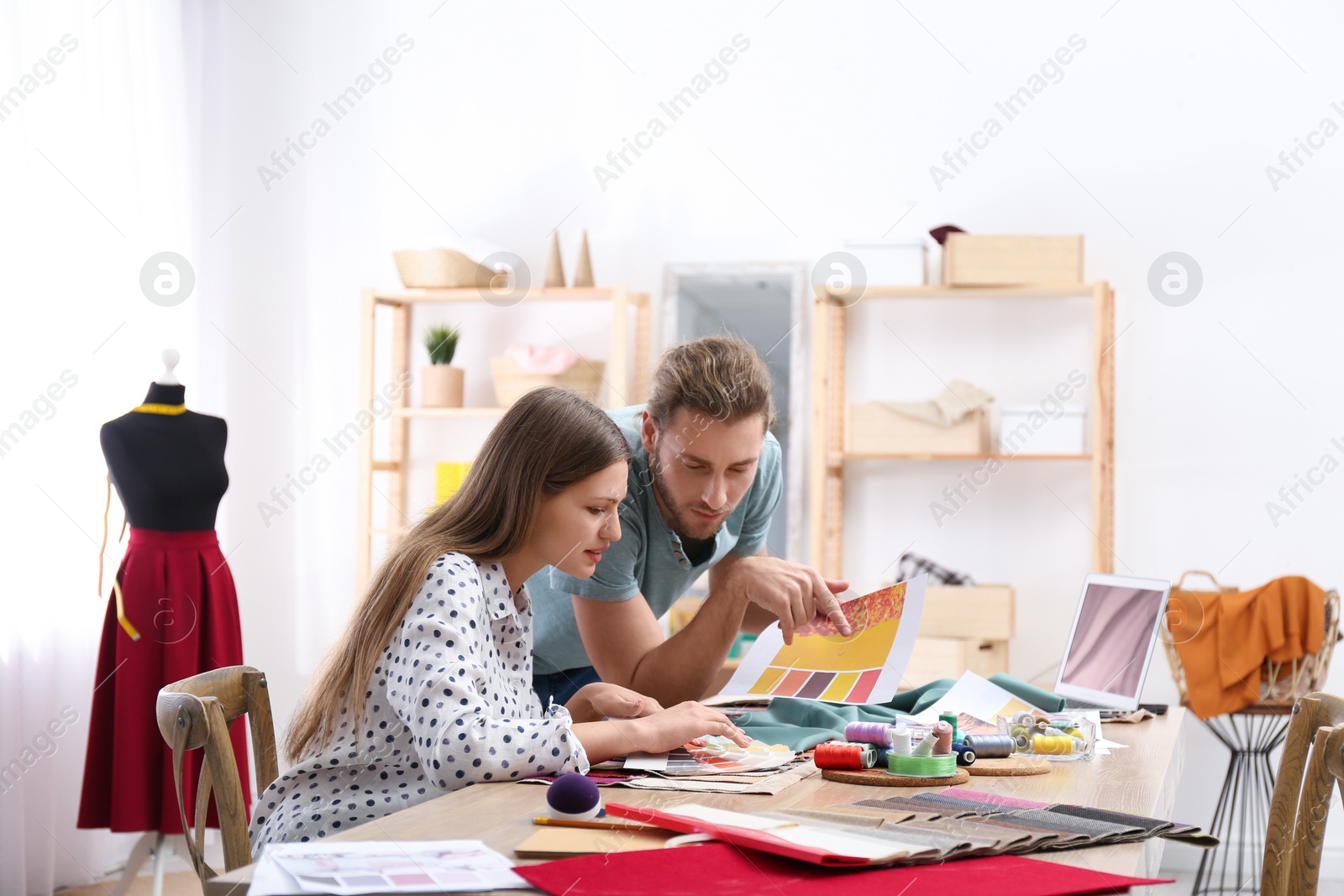 Photo of Fashion designers creating new clothes in studio