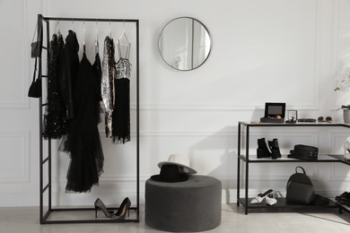 Stylish dressing room interior with trendy clothes, shoes and accessories