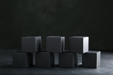 Photo of Word KEYWORD made of black cubes on dark background