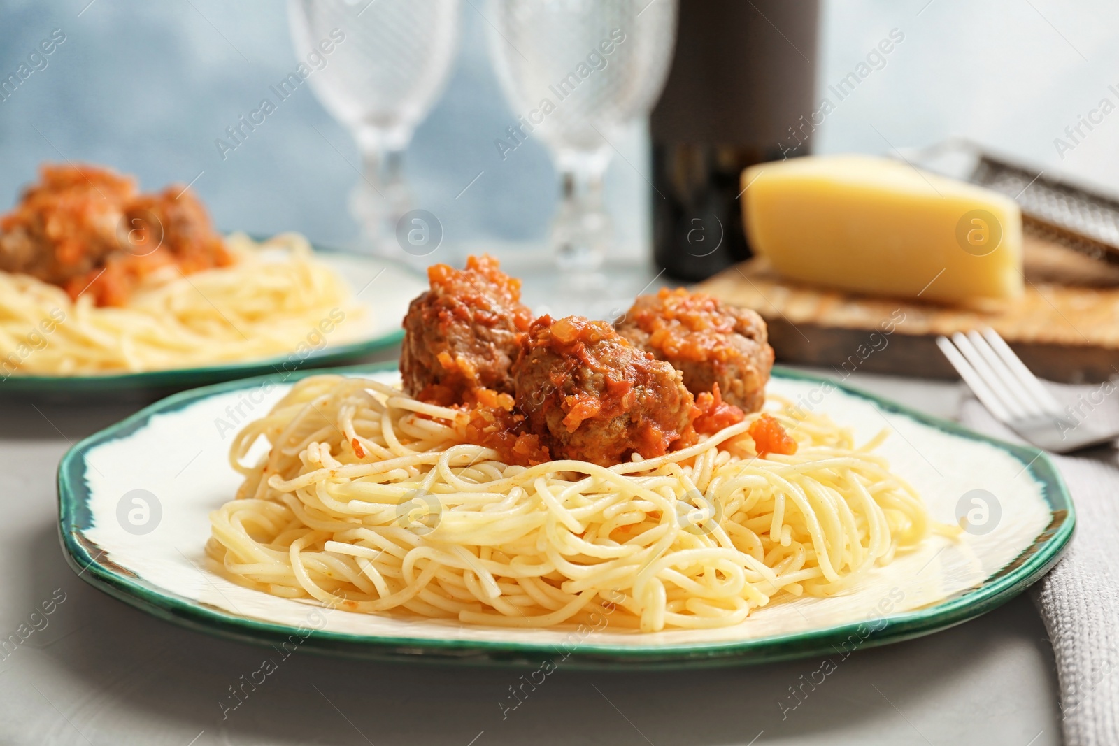 Photo of Delicious pasta with meatballs and tomato sauce on table