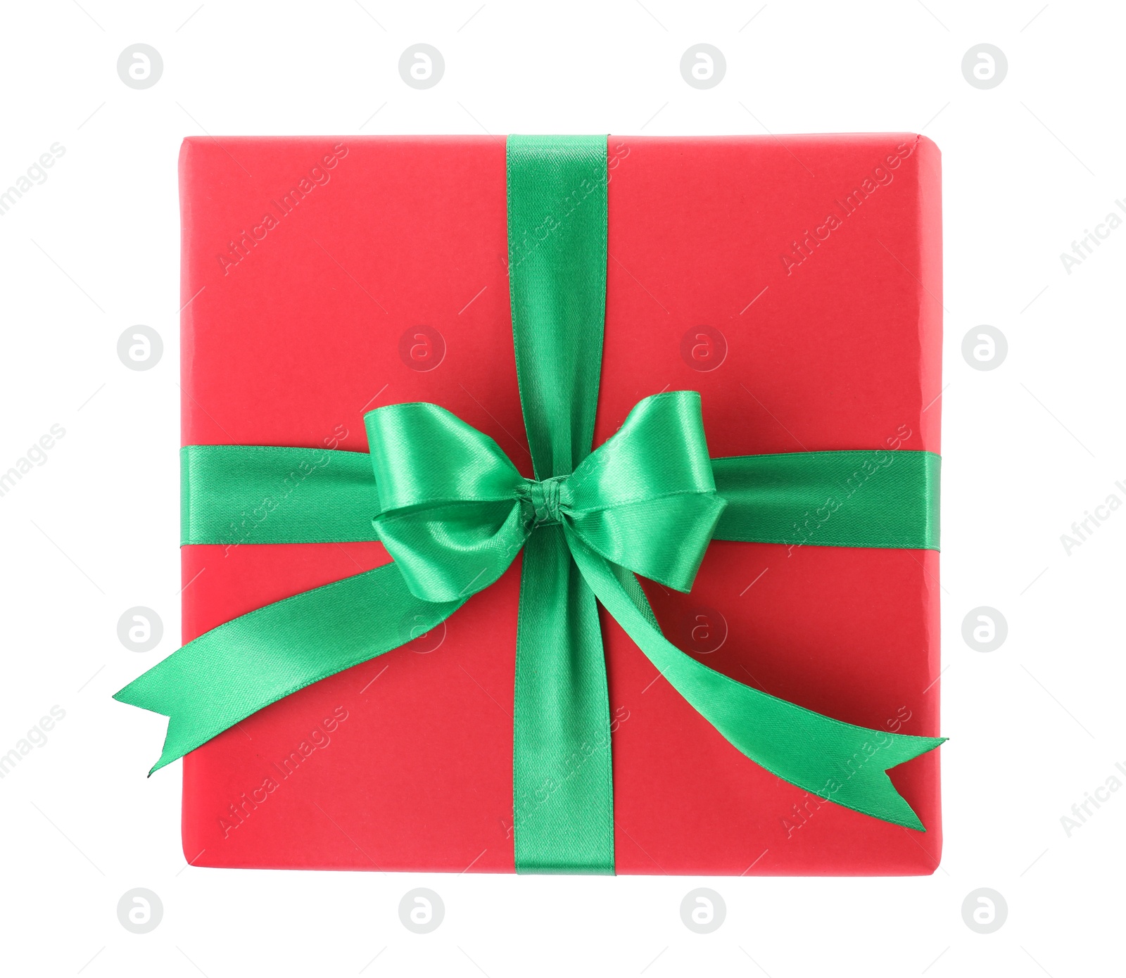 Photo of Christmas gift box decorated with ribbon bow on white background, top view