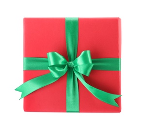 Photo of Christmas gift box decorated with ribbon bow on white background, top view