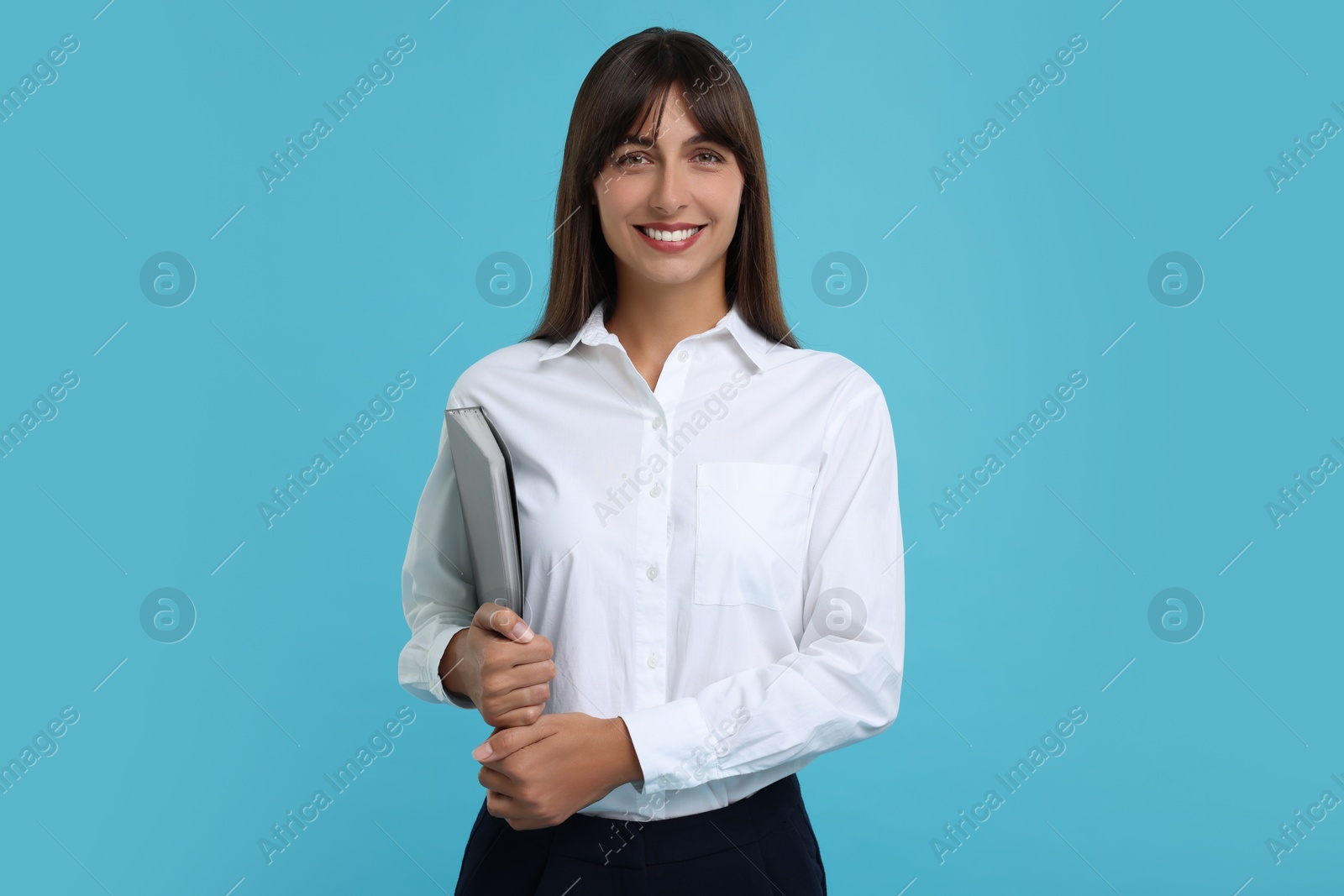 Photo of Happy secretary with folder on light blue background