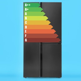 Energy efficiency rating label and refrigerator on light blue background