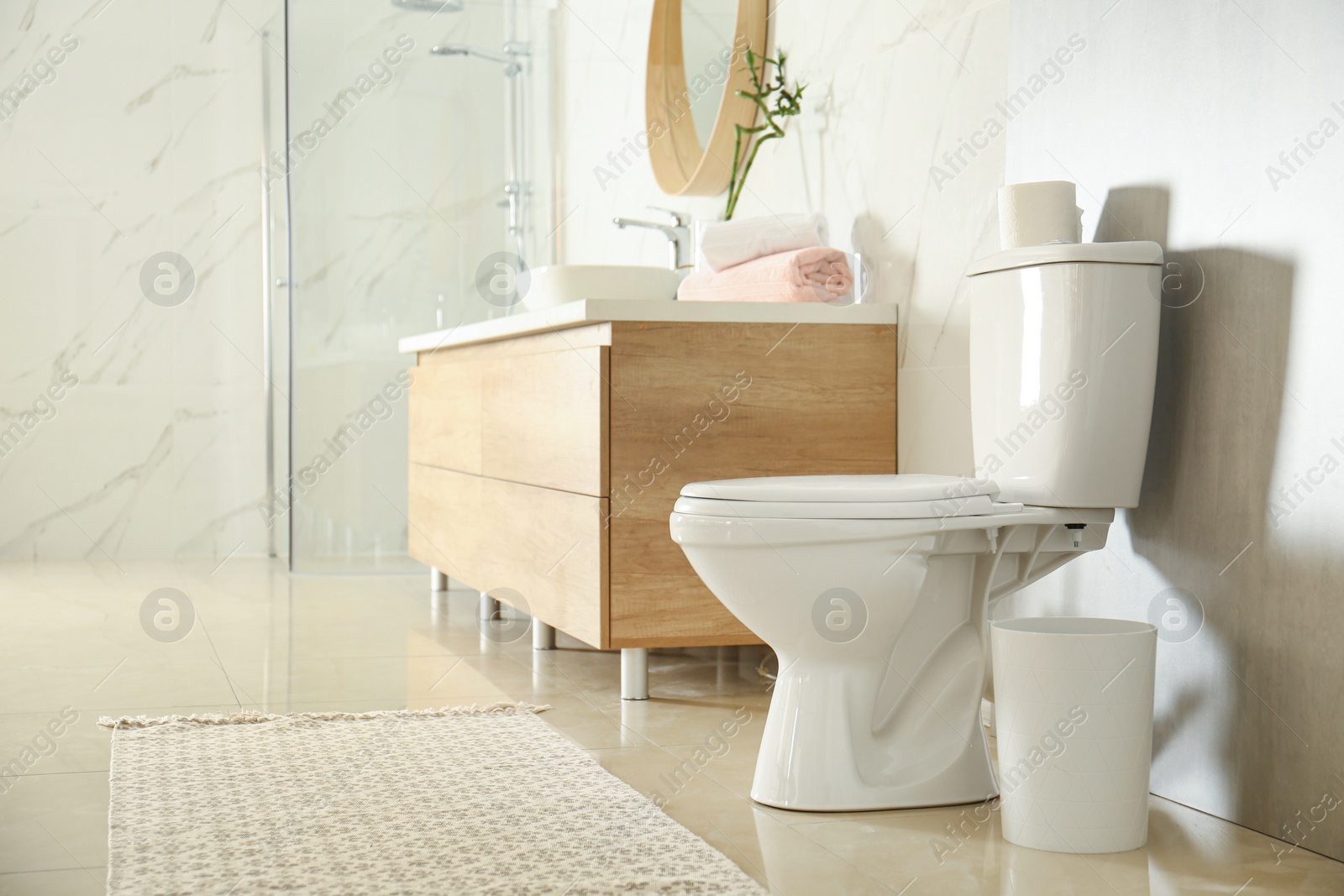 Photo of White toilet bowl in modern bathroom interior