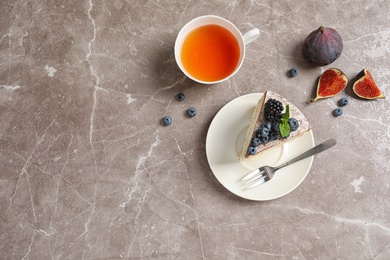 Flat lay composition with piece of delicious cake on table and space for text. Homemade pastry with fresh berries