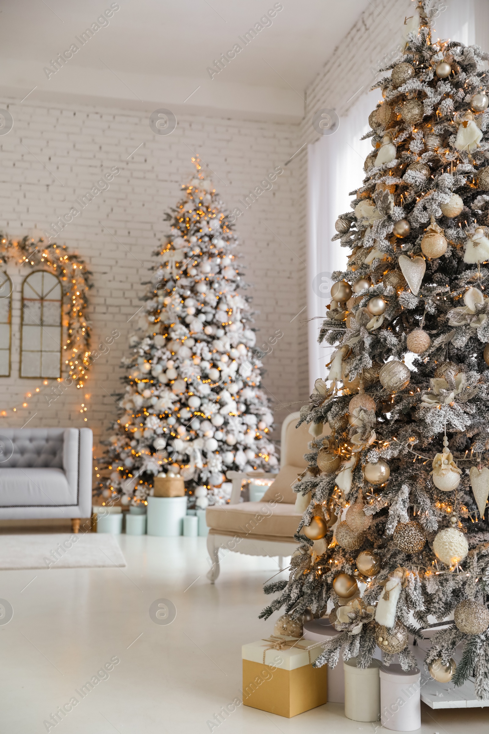 Photo of Beautiful interior of living room with decorated Christmas trees