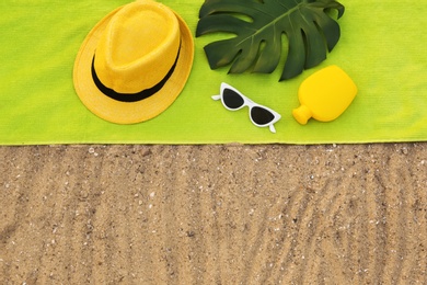 Photo of Composition with beach accessories on sand, flat lay. Space for text