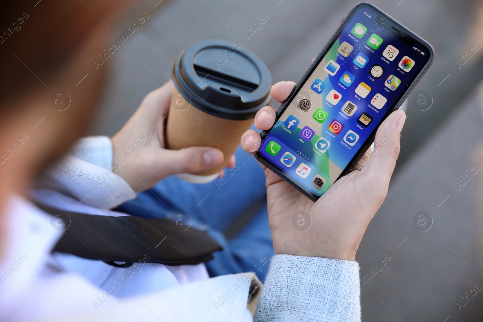 Photo of MYKOLAIV, UKRAINE - MARCH 16, 2020: Man holding iPhone 11 with home screen outdoors, closeup