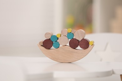 Wooden pieces of balancing game on white table indoors, closeup. Educational toy for motor skills development