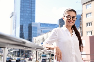 Photo of Beautiful businesswoman with glasses on city street