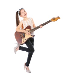 Photo of Little cheerful girl in mother's shoes playing guitar, isolated on white