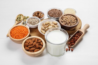 Photo of Different products high in natural fats on white wooden table