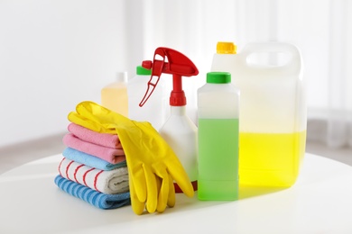 Photo of Set of professional cleaning supplies on table indoors