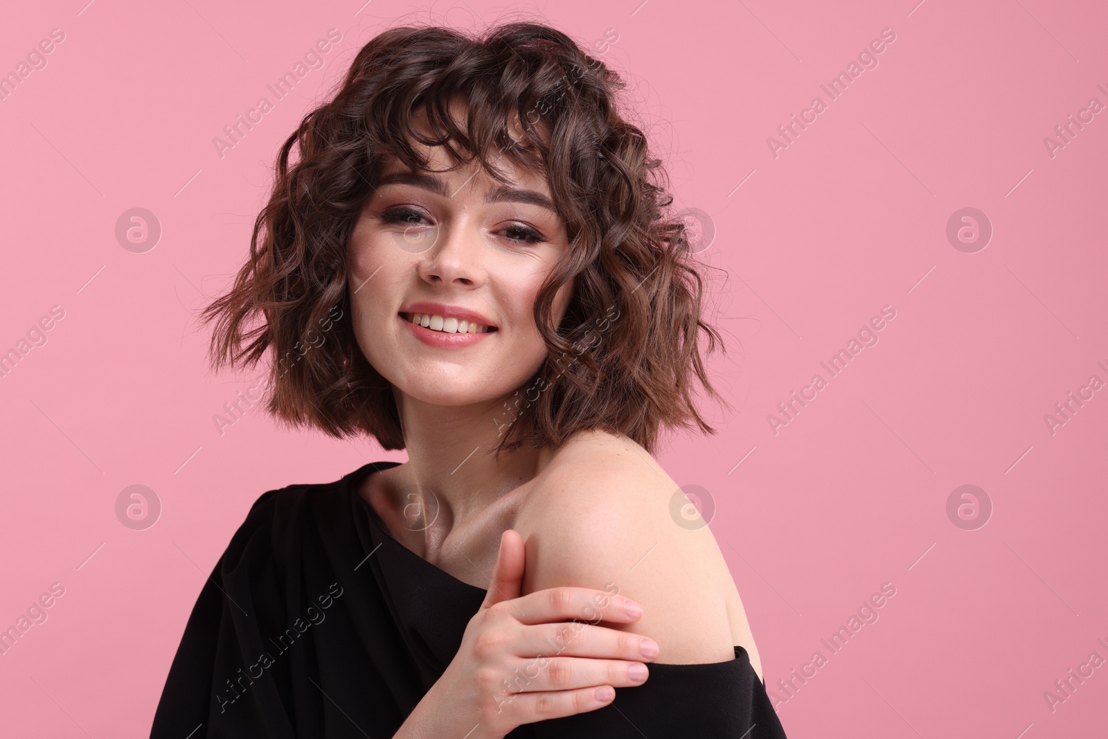 Photo of Portrait of beautiful young woman with wavy hairstyle on pink background. Space for text