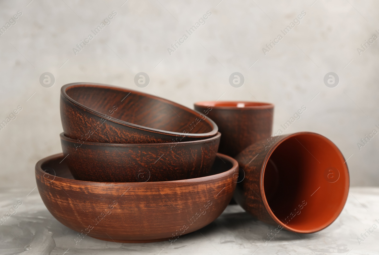 Photo of Set of clay utensils on light grey table