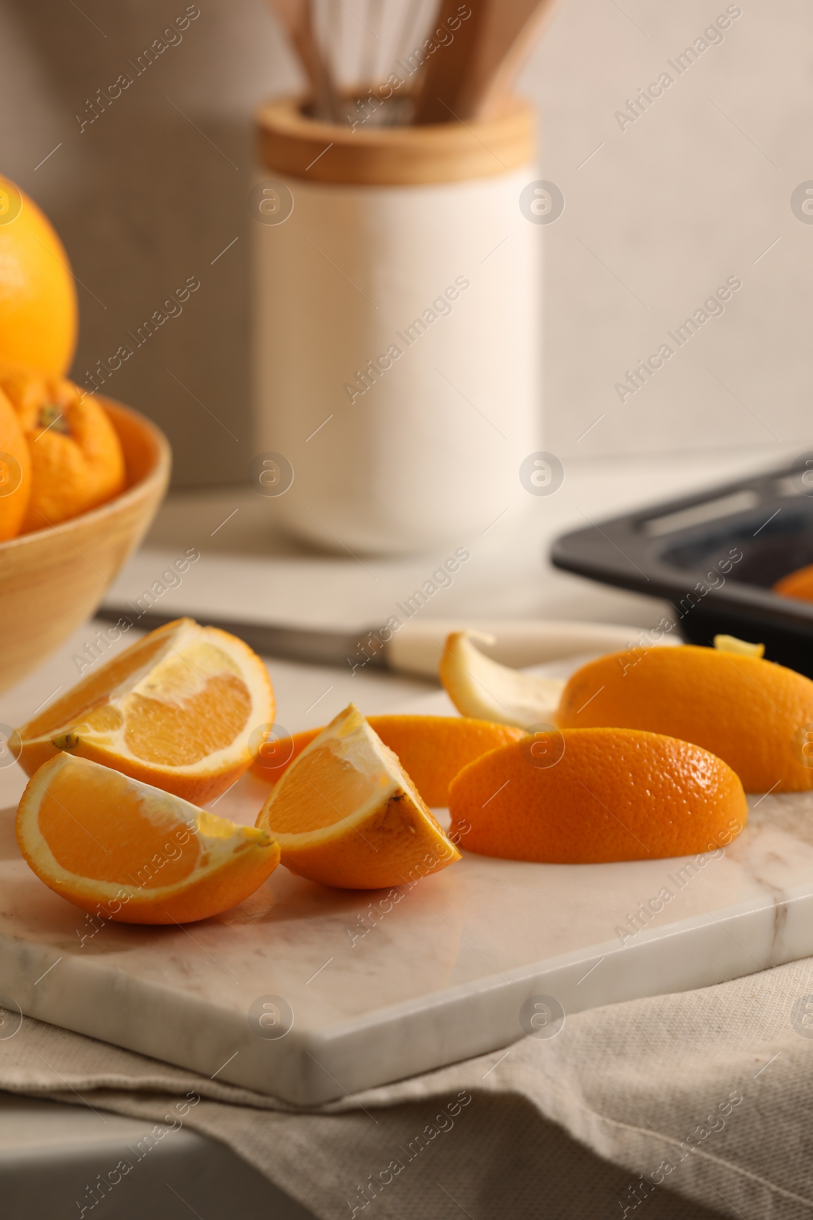 Photo of Fresh orange peels and juicy fruits on white table