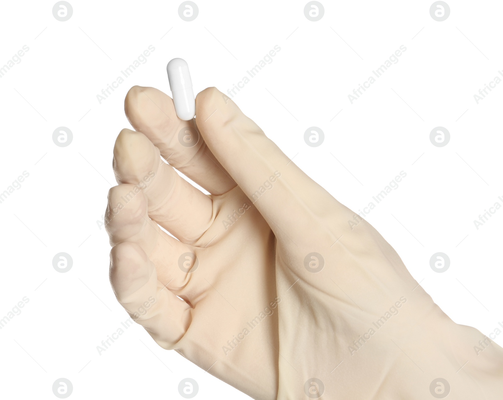 Photo of Doctor in medical glove holding pill on white background