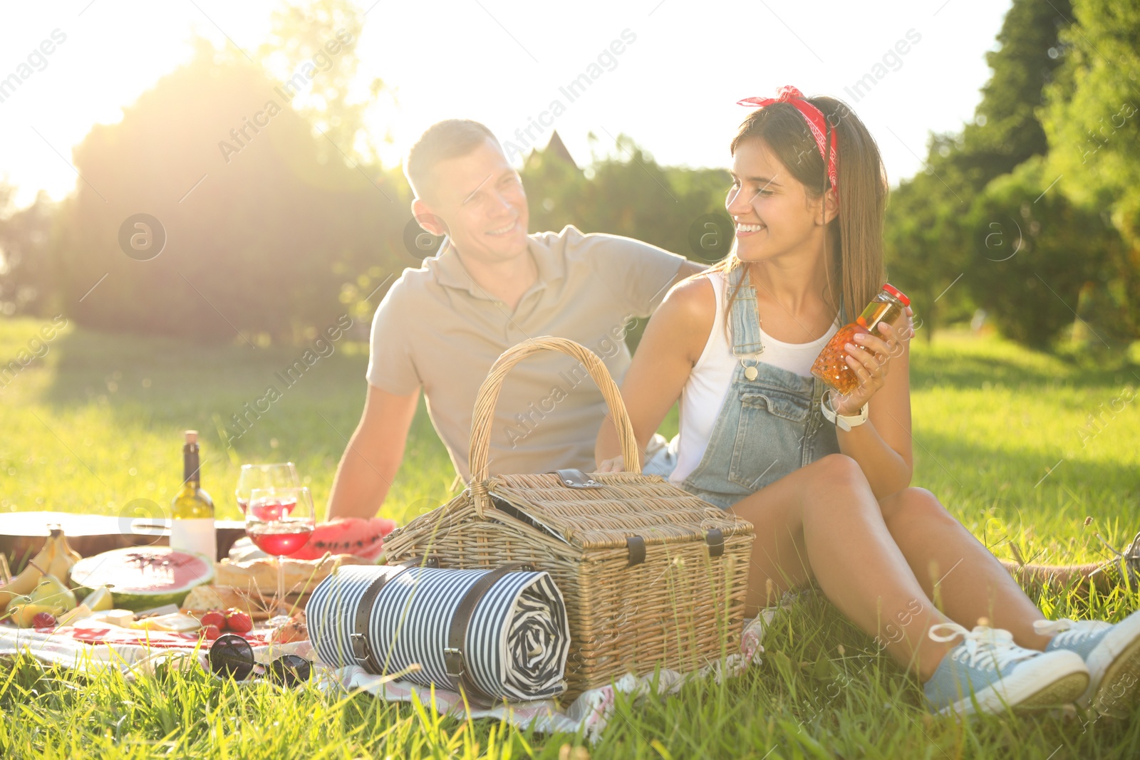 Photo of Happy couple having picnic in park on sunny day