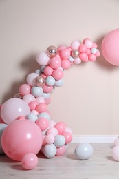 Beautiful composition with balloons near beige wall