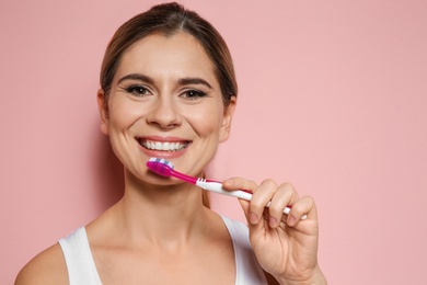 Photo of Portrait of woman with toothbrush on color background. Space for text