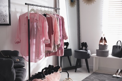 Dressing room interior with clothing rack and comfortable chair