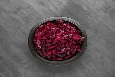 Photo of Tasty red cabbage sauerkraut on grey table, top view