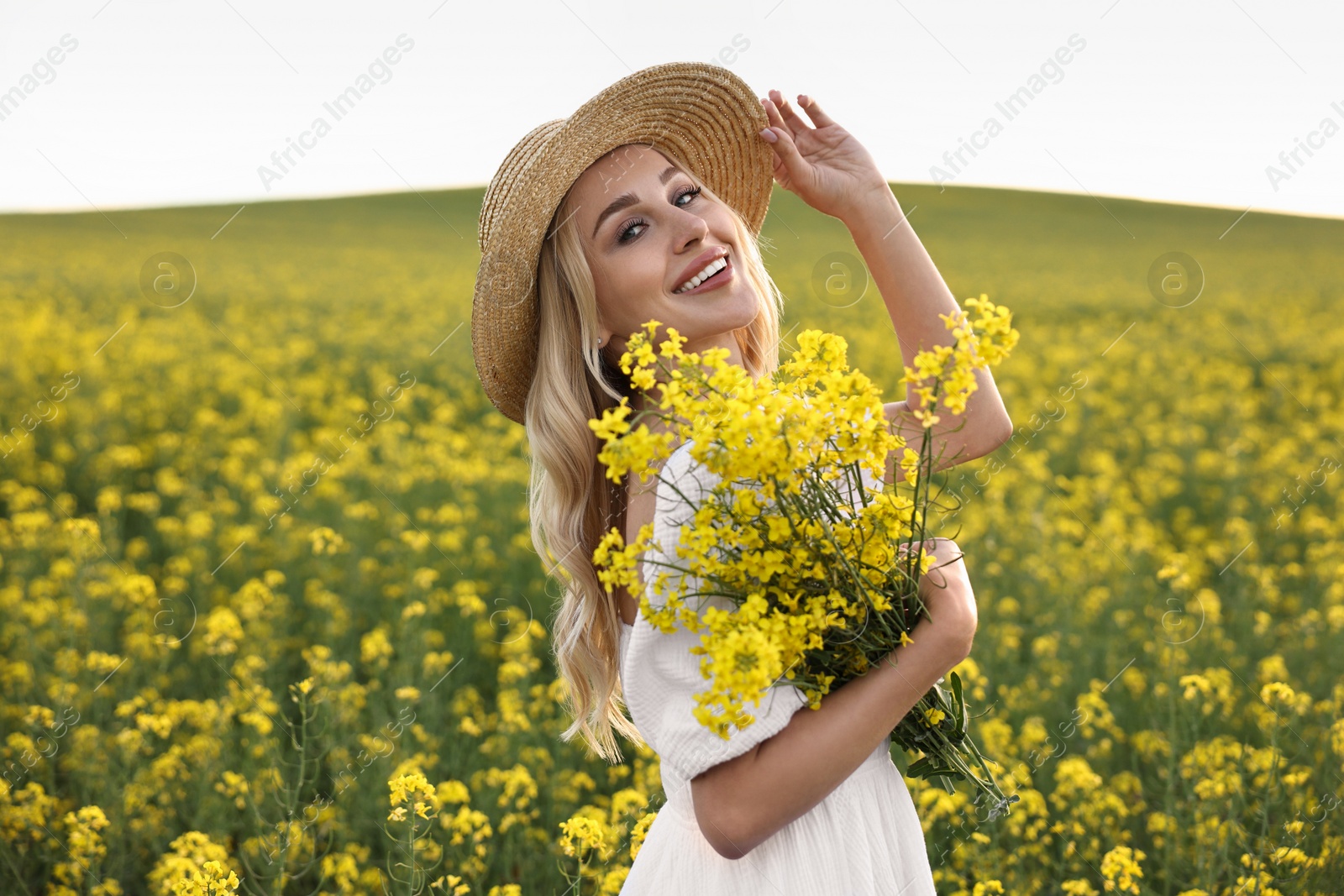 Photo of Portrait of happy young woman in field on spring day