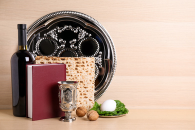 Photo of Symbolic Pesach (Passover Seder) items on wooden table, space for text