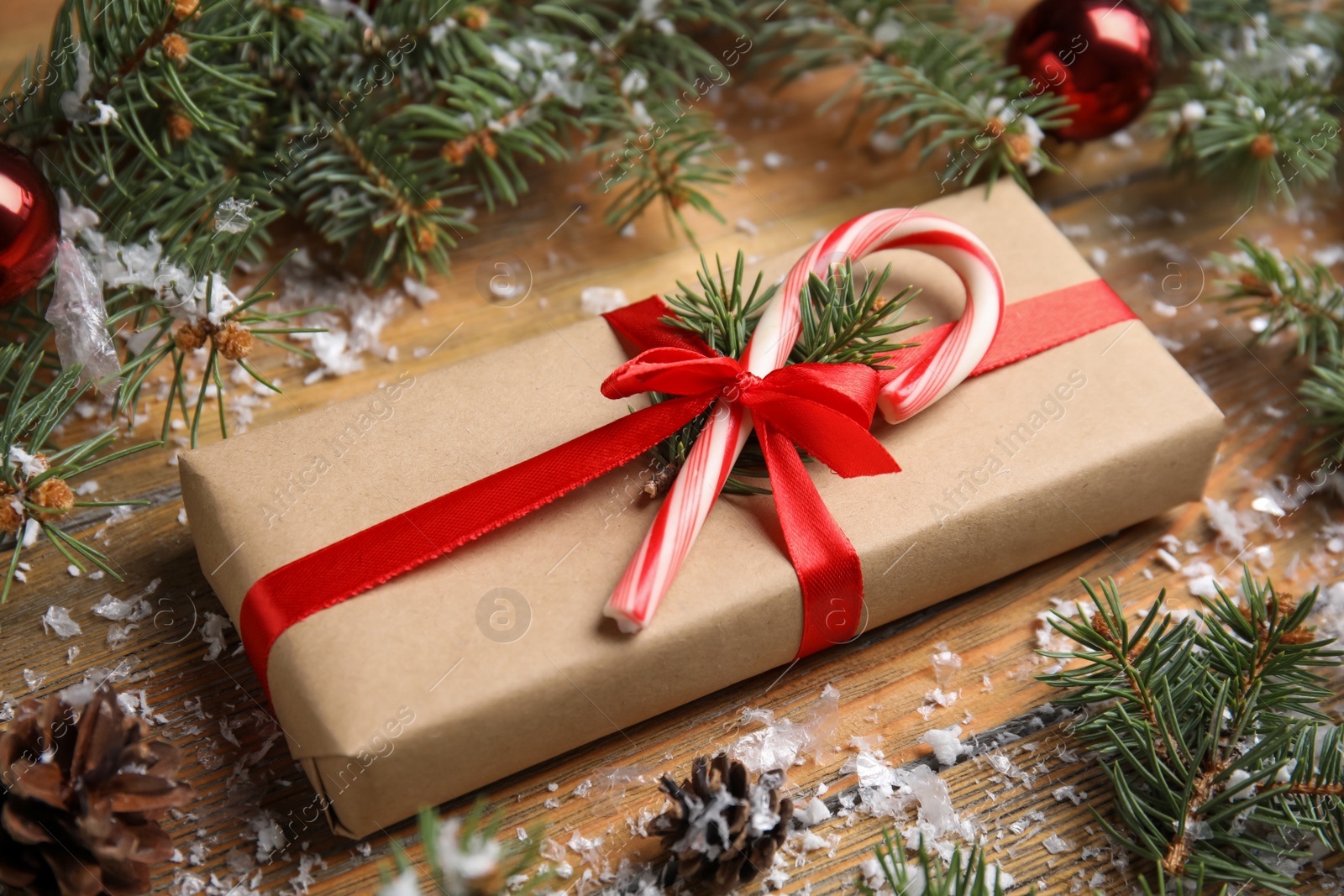 Photo of Beautiful gift box and Christmas decor on wooden table