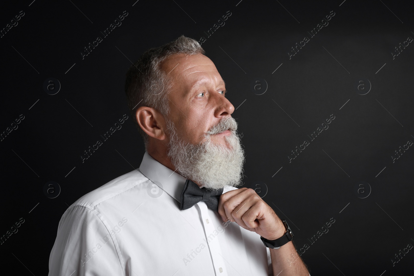 Photo of Portrait of handsome senior man on black background
