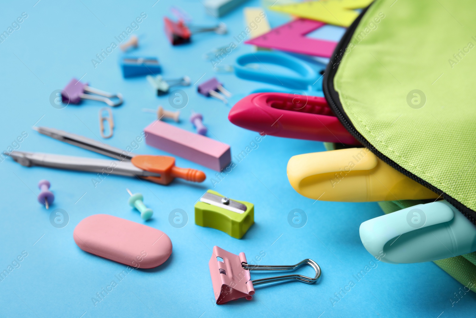 Photo of Back to school. Many different school stationery on light blue background