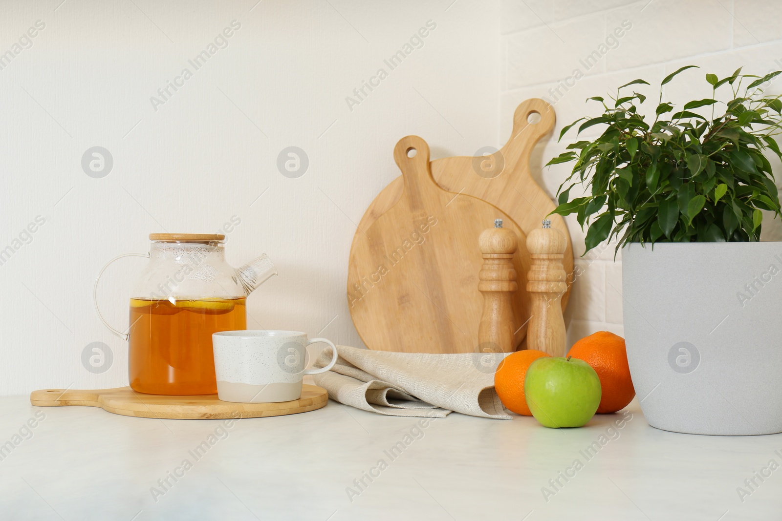 Photo of Different kitchen items and houseplant on countertop indoors