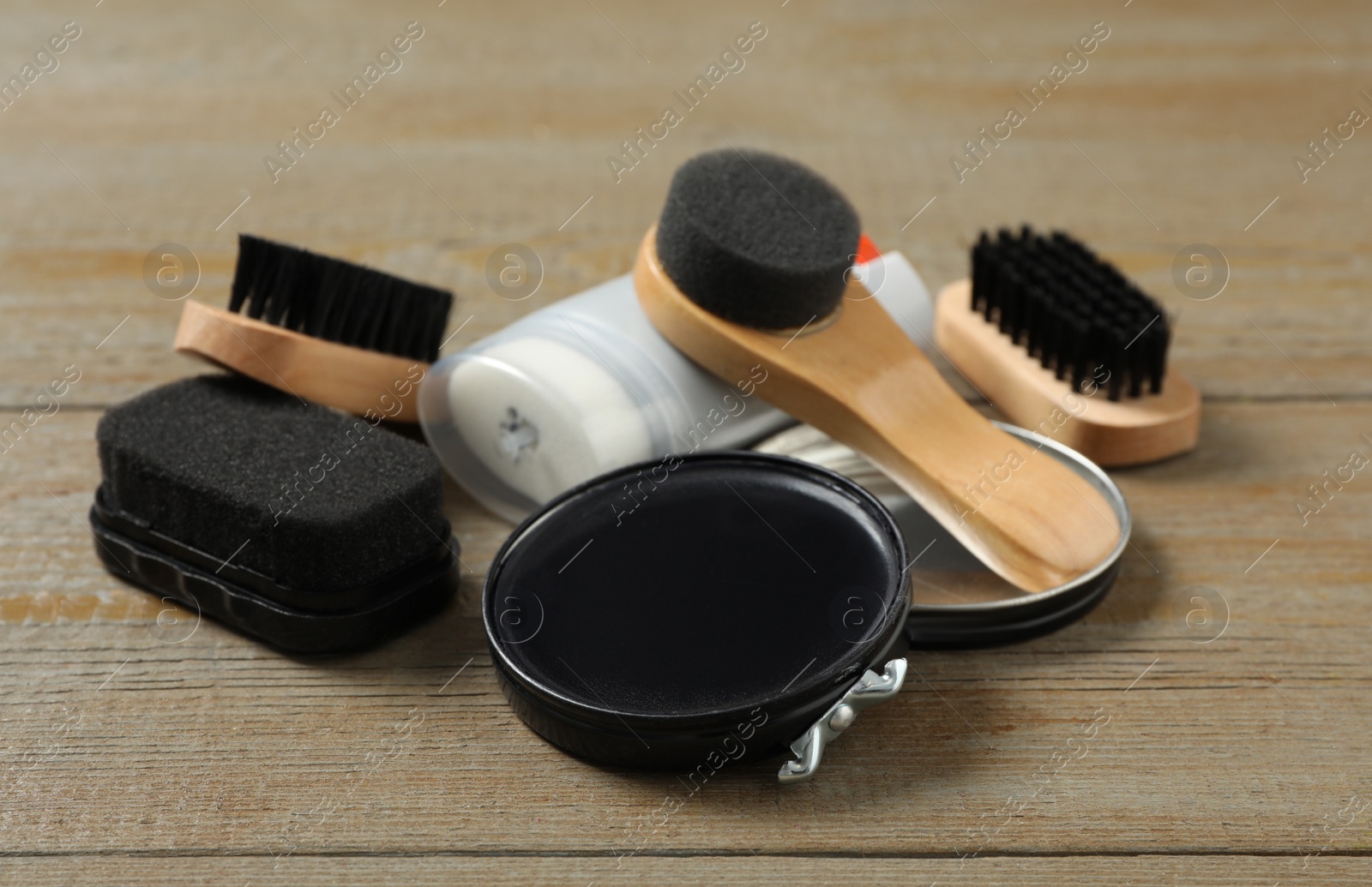 Photo of Composition with shoe care accessories on wooden background, closeup