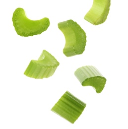 Image of Cut fresh green celery falling on white background