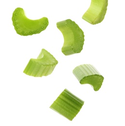 Cut fresh green celery falling on white background