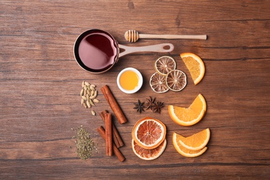 Photo of Flat lay composition with ingredients for mulled wine on wooden background