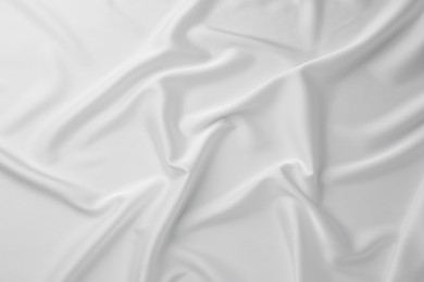 Texture of crumpled white silk fabric as background, top view