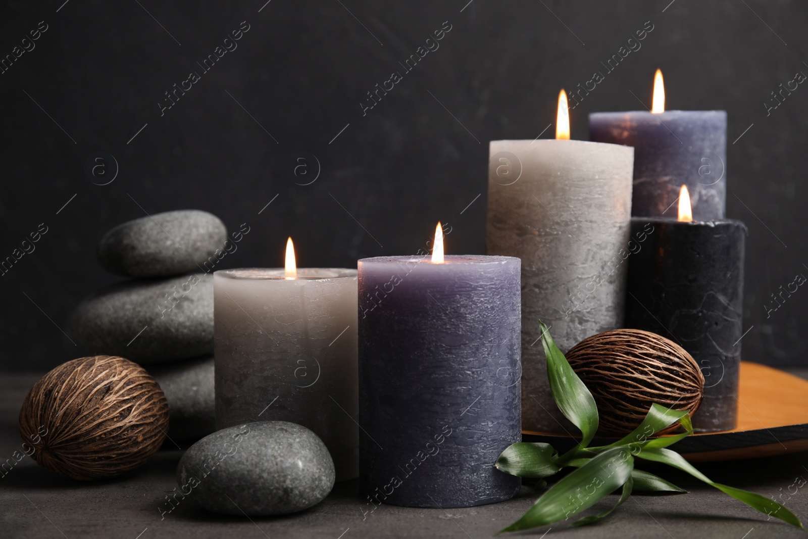 Photo of Spa composition with burning candles on table