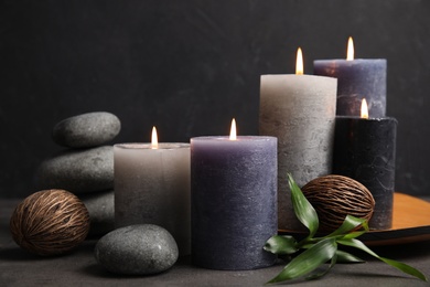 Photo of Spa composition with burning candles on table