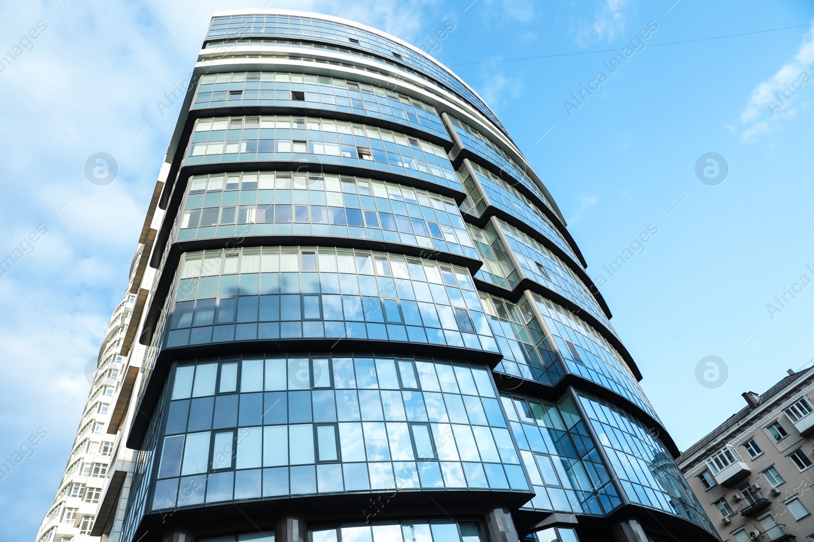 Photo of KYIV, UKRAINE - MAY 23, 2019: Modern office building against blue sky