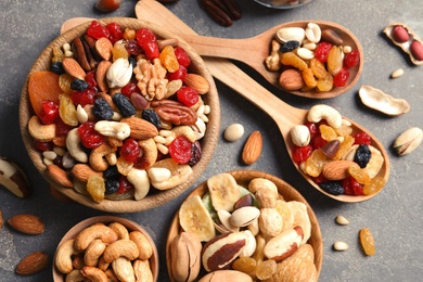 Photo of Flat lay composition of different dried fruits and nuts on color background