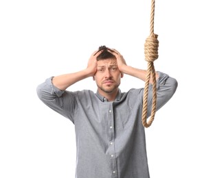 Depressed man with rope noose on white background