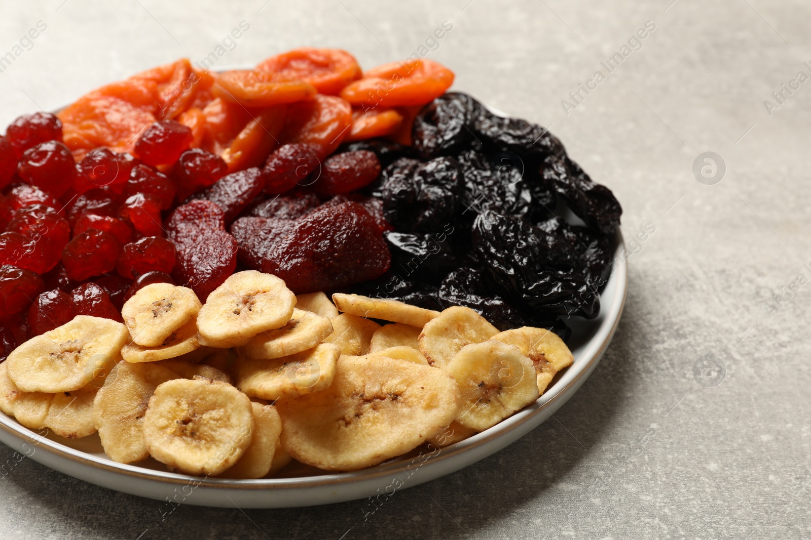 Photo of Delicious dried fruits on grey table, closeup